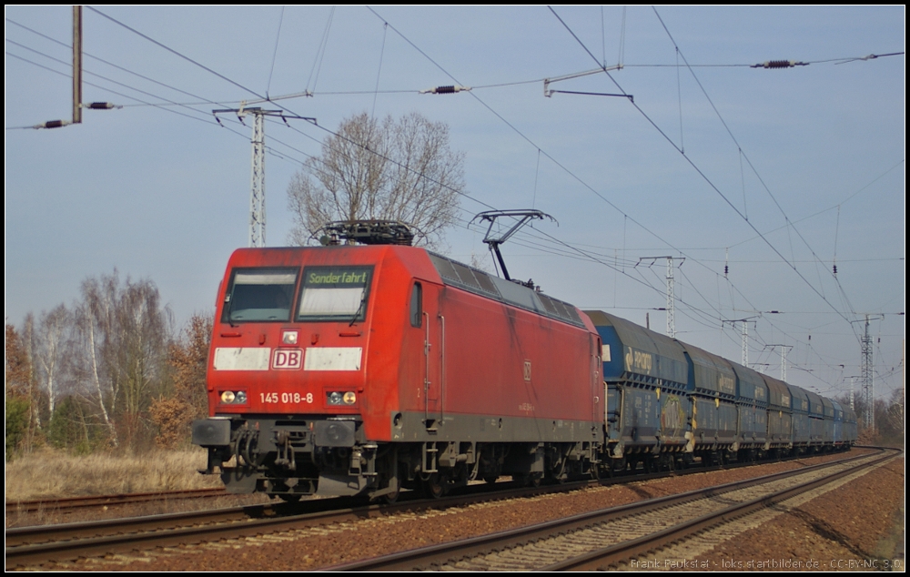 DB Schenker 145 018 mit einem Erzzug am 06.03.2013 in der Berliner Wuhlheide