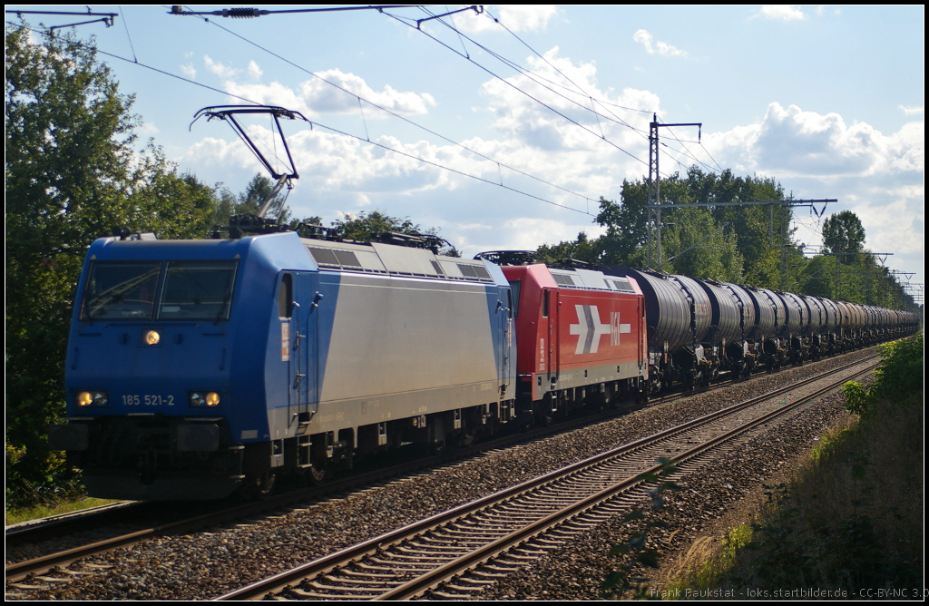 RheinCargo 185 521-2 und Wagenlok 185 604 mit Knickkesselwagen-Zug am 11.08.2014 durch Panketal-R�ntgental