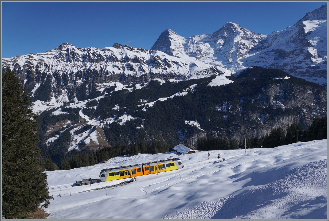 Was für ein Panorama: Eiger, Mönch und  Jungfrau ! Der BLM Be 4/6 103  Jungfrau  ist als R66 auf der Fahrt von Mürren nach Grütschalp. 

18. Februar 2018