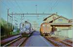 Schönbühl SBB mit der die Ee 3/3 116315, einem durchfahrenden Schnellzug mit der SBB Re 4/4 11348, in grün aber mit eckigen Lampen  und einem etwas  gewagten  Fotostandpunkt.

Analobbild vom Mai 1995